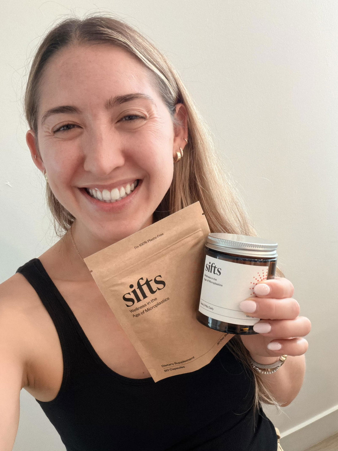 Sifts customer Nicole B. smiling with her Sifts Daily jar and pouch